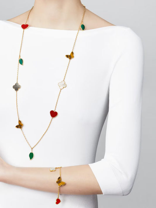 Lucky Alhambra long necklace, 12 motifs, 18K yellow gold, carnelian, tiger’s eye, white and gray mother-of-pearl, malachite.