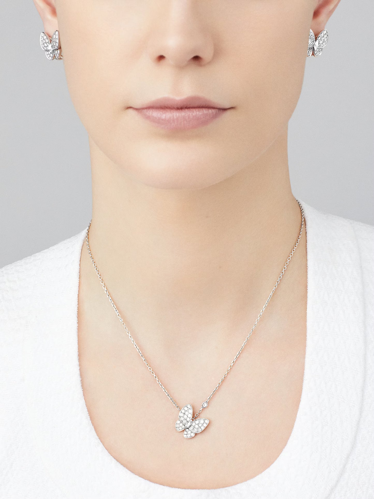 Two Butterfly pendant, rhodium plated 18K white gold, round and marquise-cut diamonds.
