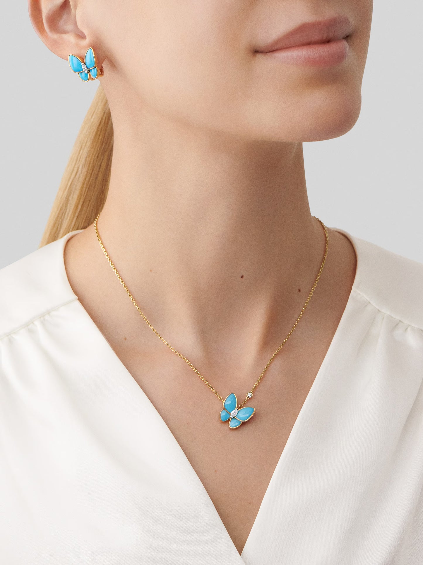 Two Butterfly pendant, 18K yellow gold, turquoise, rhodium plated 18K white gold,round and marquise-cut diamond.