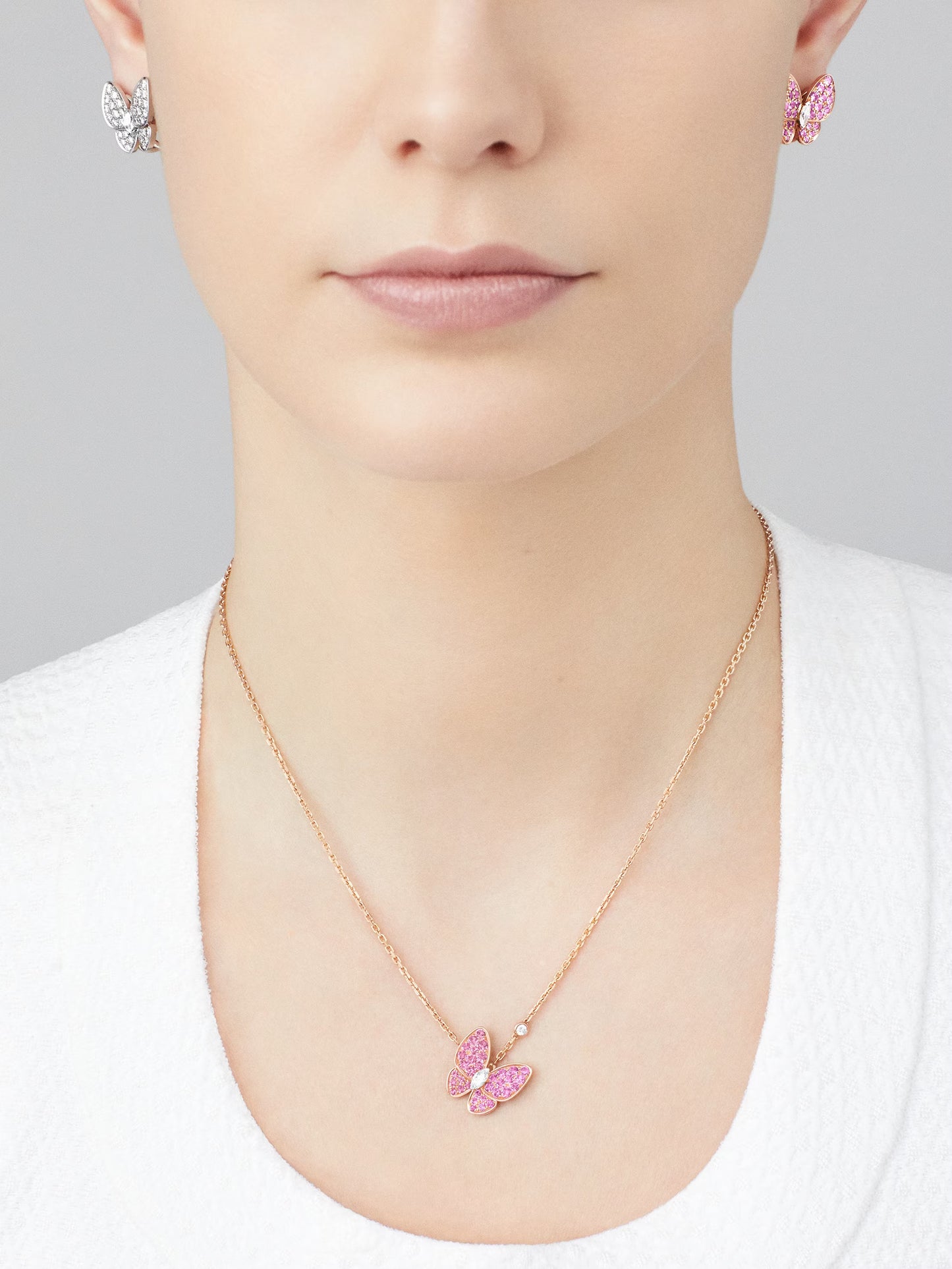 Two Butterfly pendant, 18K rose gold, rhodium plated 18K white gold, round and marquise-cut diamonds.